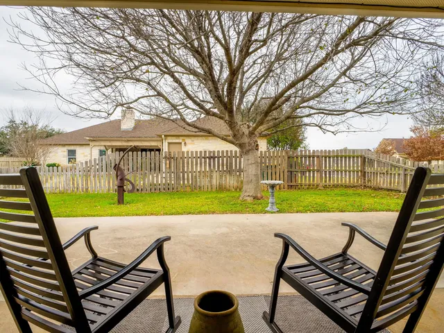 a view of a house with backyard porch and sitting area