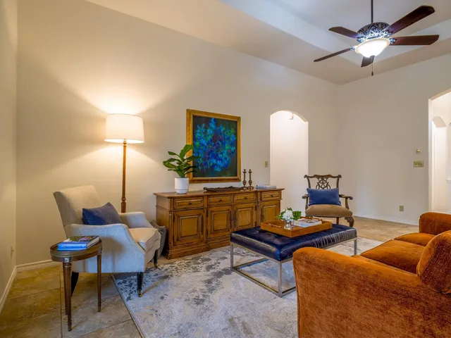 a living room with furniture a lamp and a chandelier