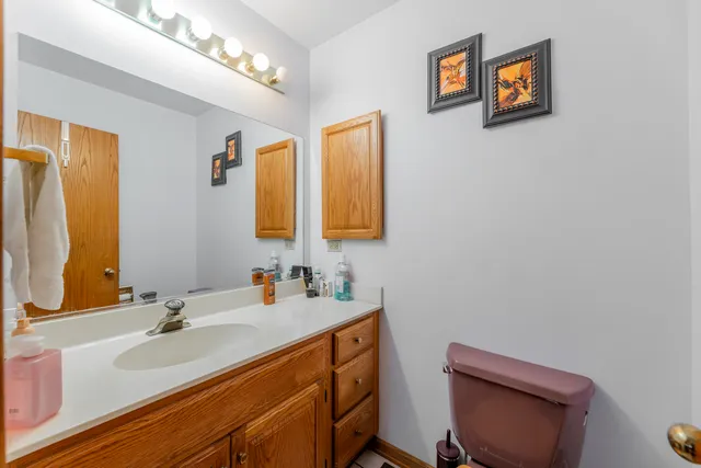 a bathroom with a sink a toilet and mirror