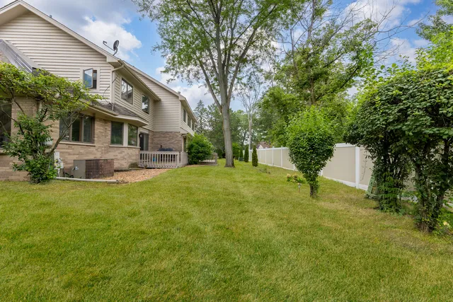 a front view of house with yard and trees