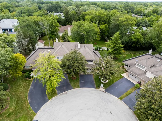 an aerial view of a house with garden space and street view