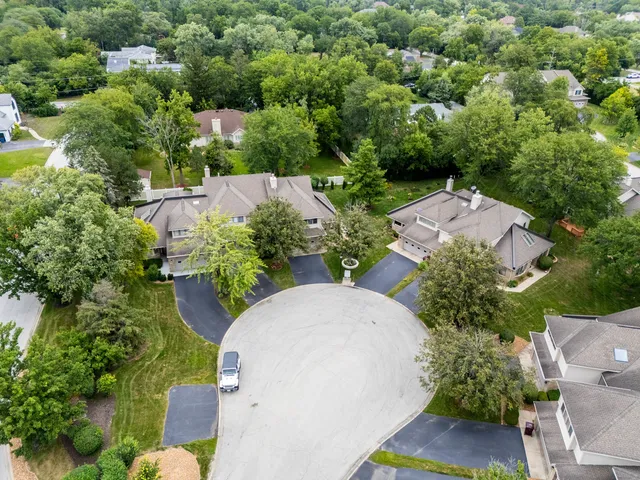 an aerial view of a house with yard and outdoor seating