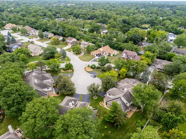 an aerial view of a house with garden space and street view