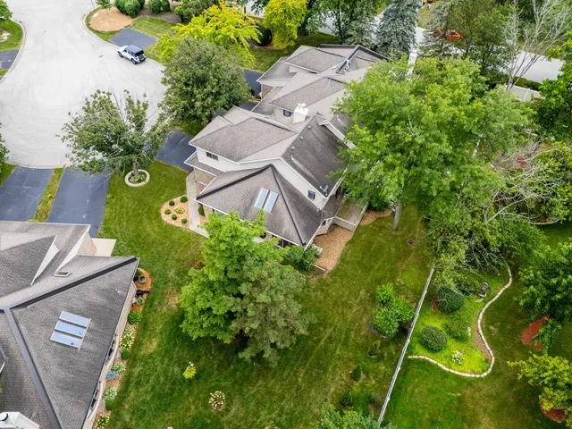 an aerial view of a house with a yard