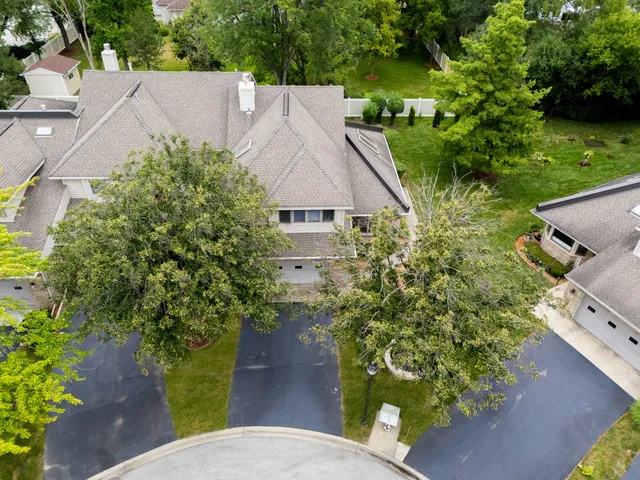 a front view of a house with a yard and tree s