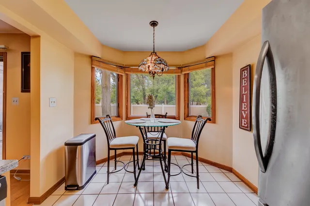 a dining room with furniture and window