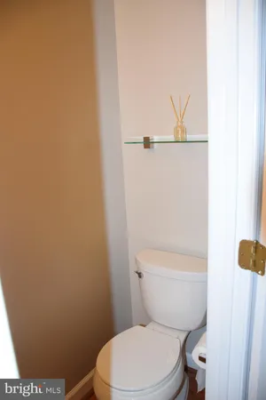 a white toilet sitting next to a shower