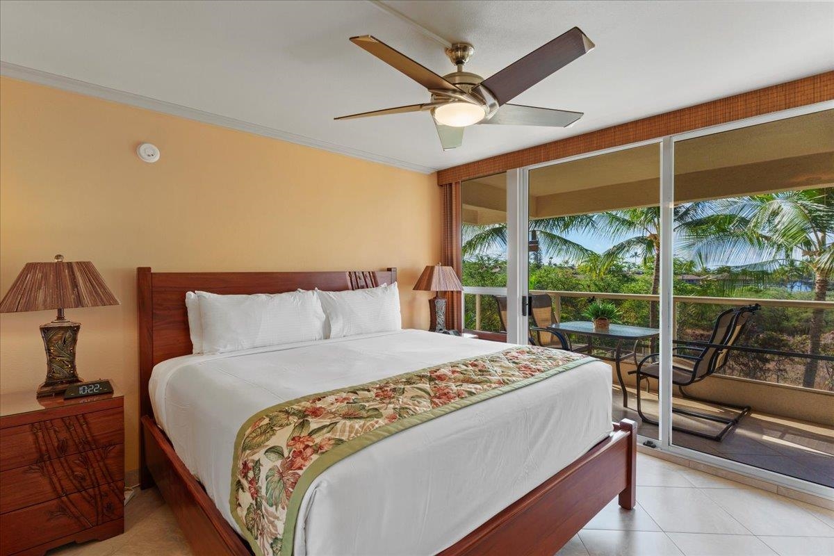 2575 South Kihei Road, Unit G409 Kihei, HI 96753 - Photo 16 of 32 a bedroom with a large bed and a large window