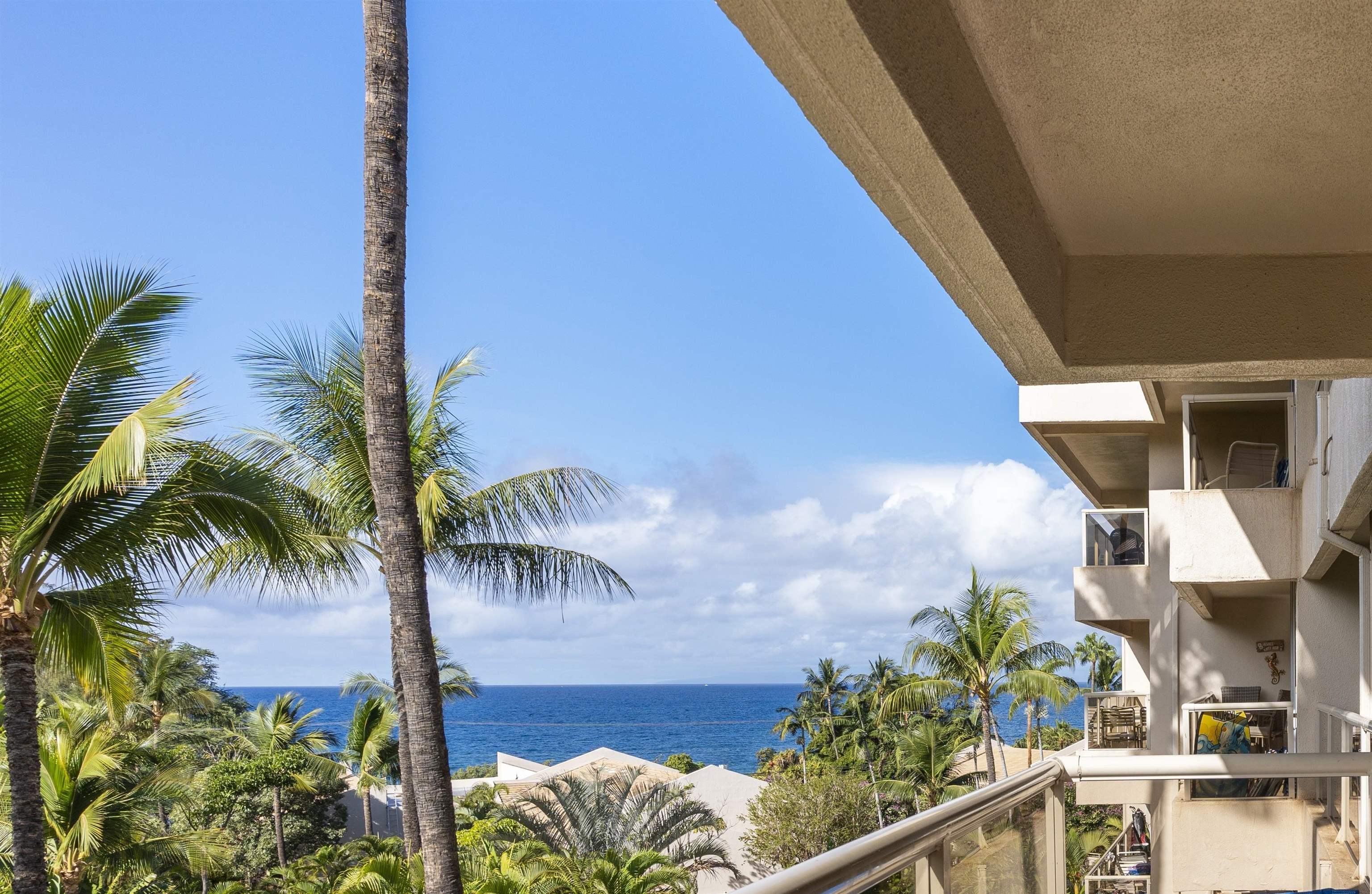 2575 South Kihei Road, Unit G409 Kihei, HI 96753 - Photo 5 of 32 a balcony with potted plants and palm trees