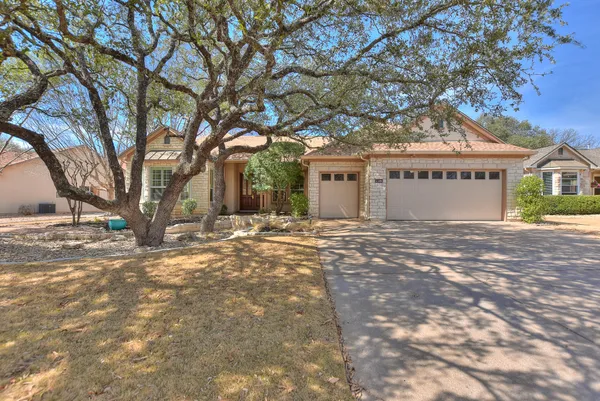 a view of large tree in front of a house
