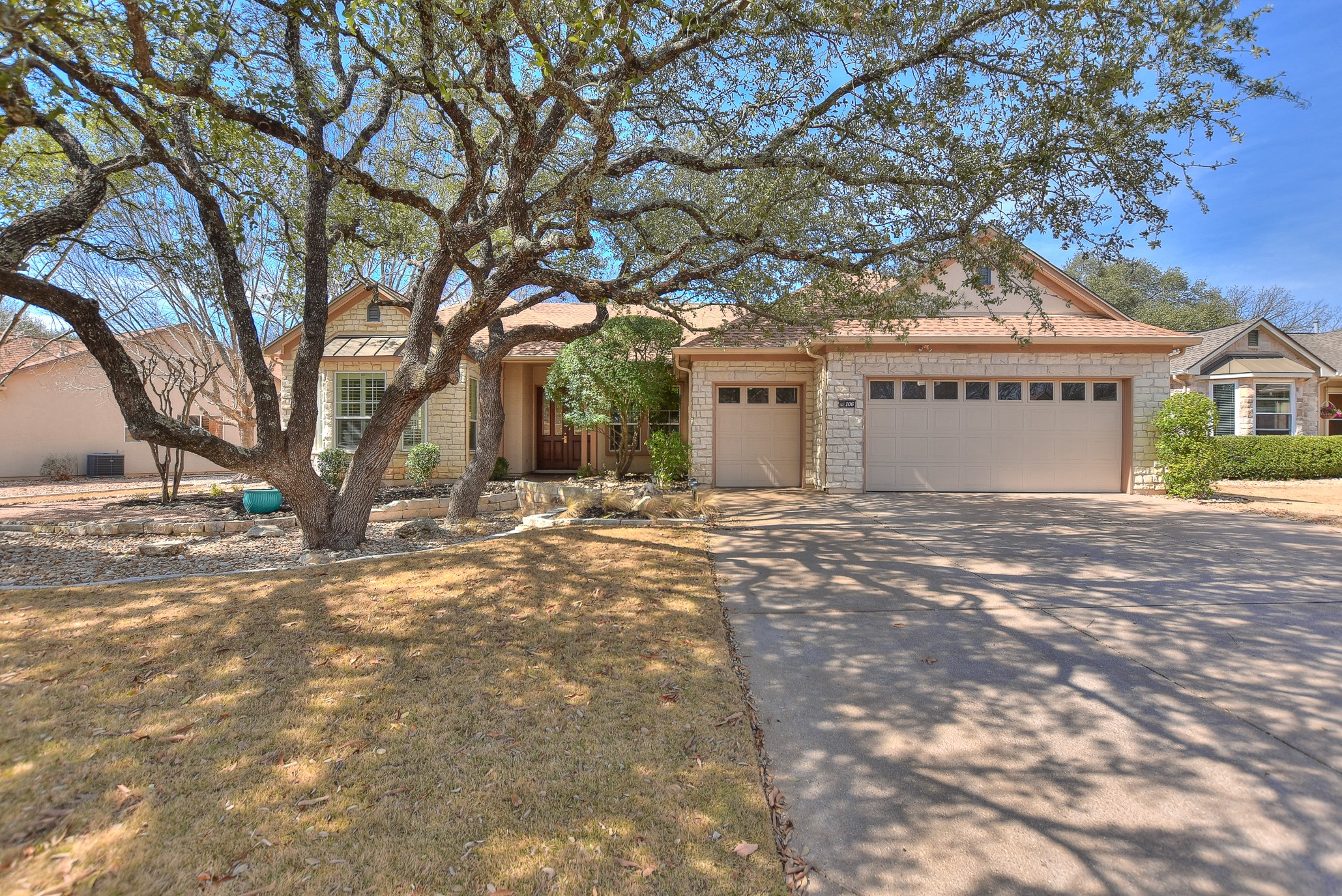 a view of large tree in front of a house