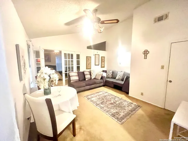 a living room with furniture rug and a table