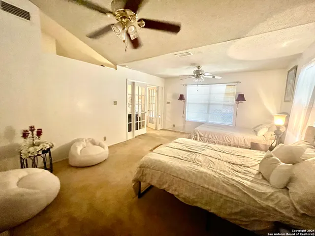 a bedroom with a bed and ceiling fan