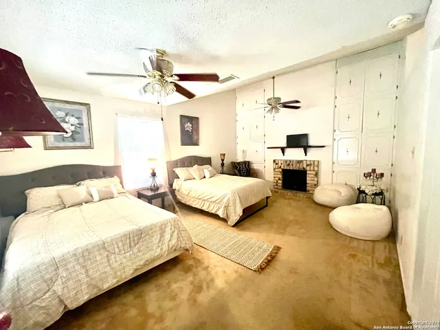 a spacious bedroom with two beds and a chandelier
