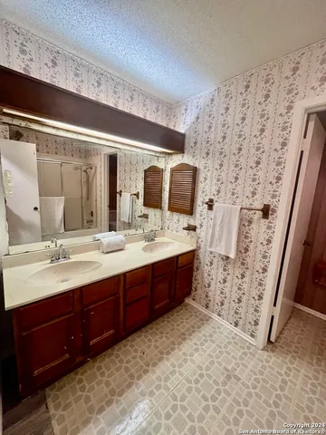 a spacious bathroom with a double vanity sink mirror and double