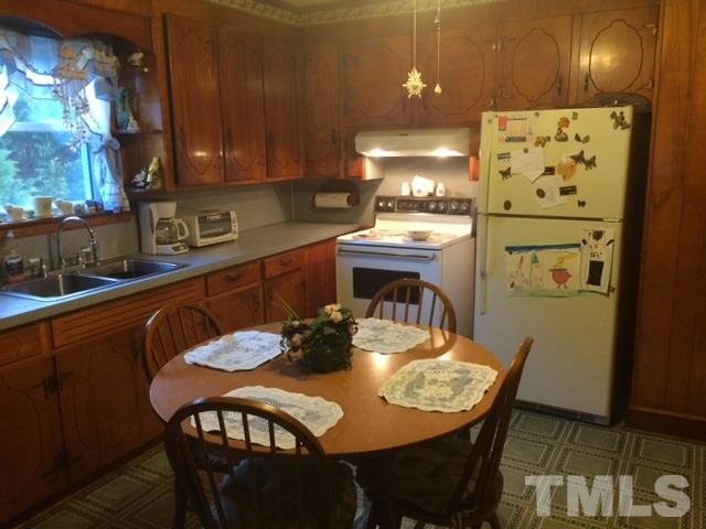 419 Edgar Street Roxboro, NC 27573 - Photo 13 of 18 a view of a dining room with furniture and wooden floor