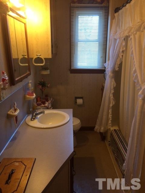 419 Edgar Street Roxboro, NC 27573 - Photo 18 of 18 a bathroom with a sink a toilet a mirror and tub