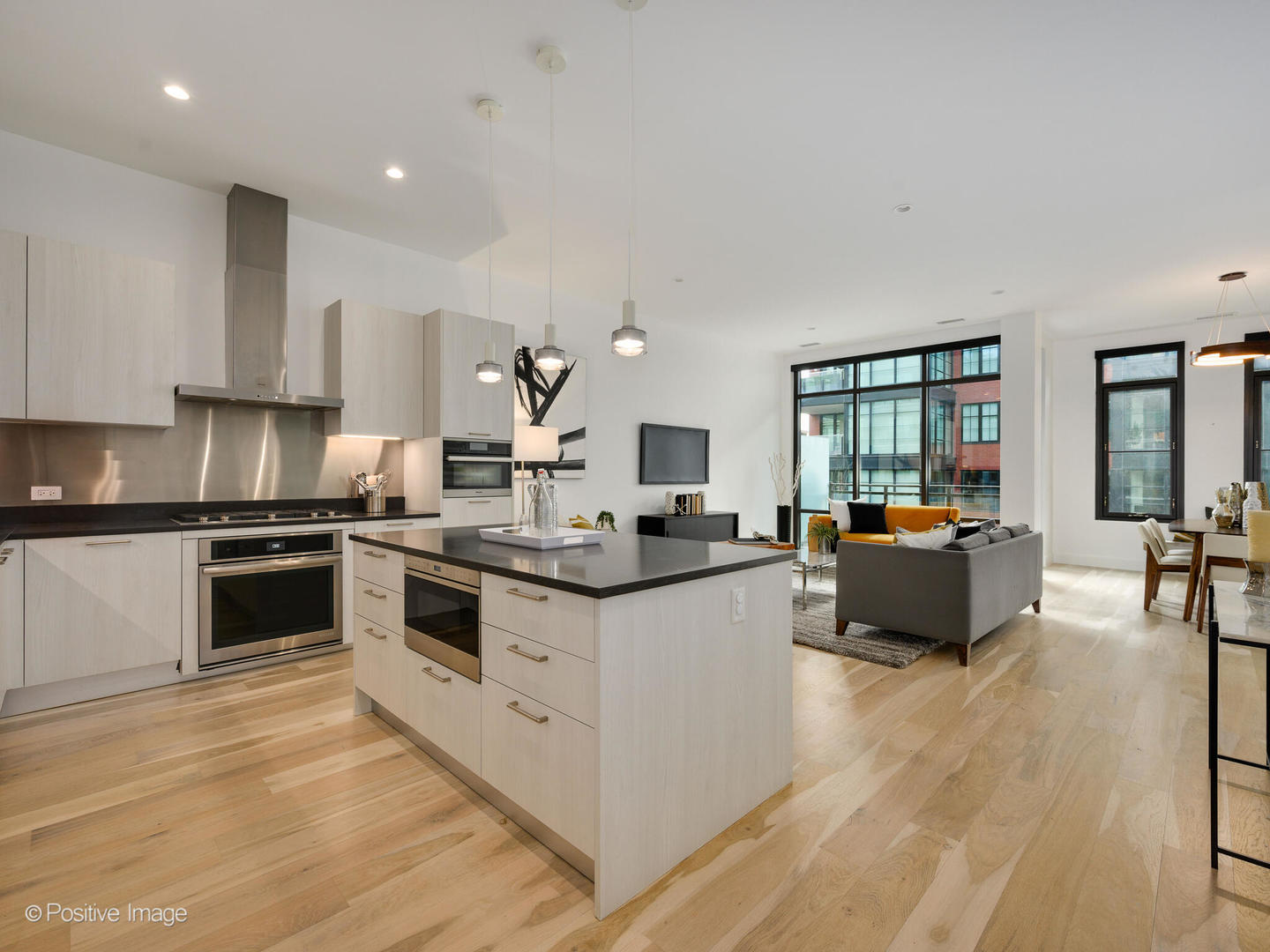 39 North Aberdeen Street, Unit 4S Chicago, IL 60607 - Photo 4 of 25 a large white kitchen with stainless steel appliances