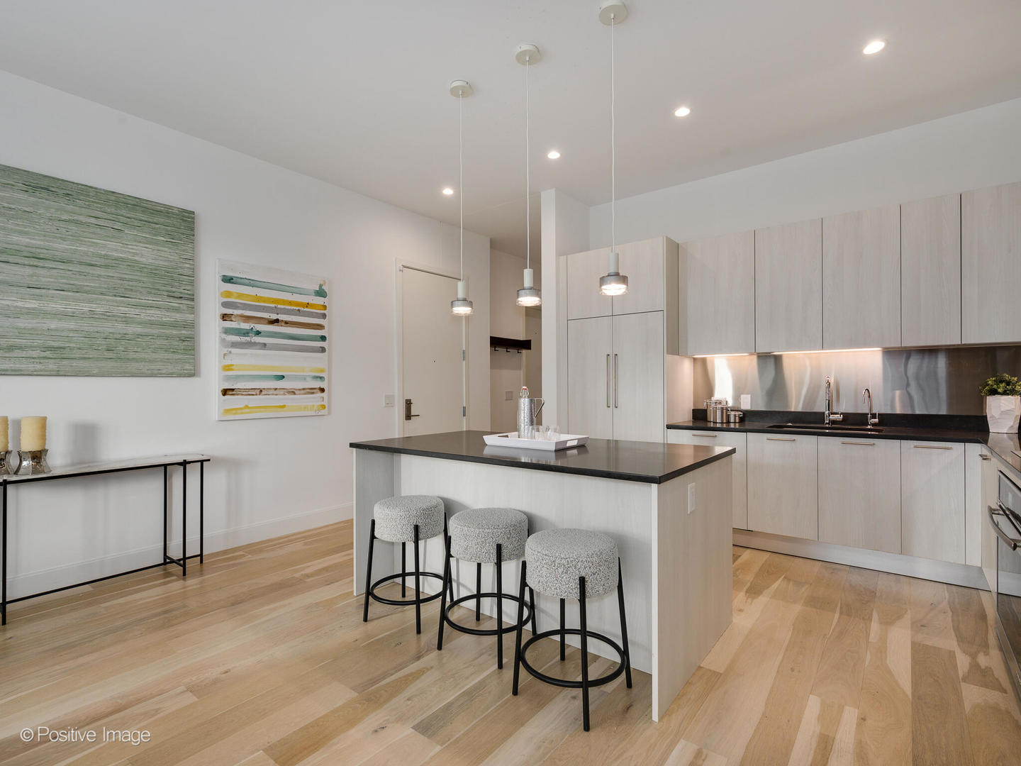 39 North Aberdeen Street, Unit 4S Chicago, IL 60607 - Photo 6 of 25 a kitchen with stainless steel appliances granite countertop a table chairs sink and cabinets