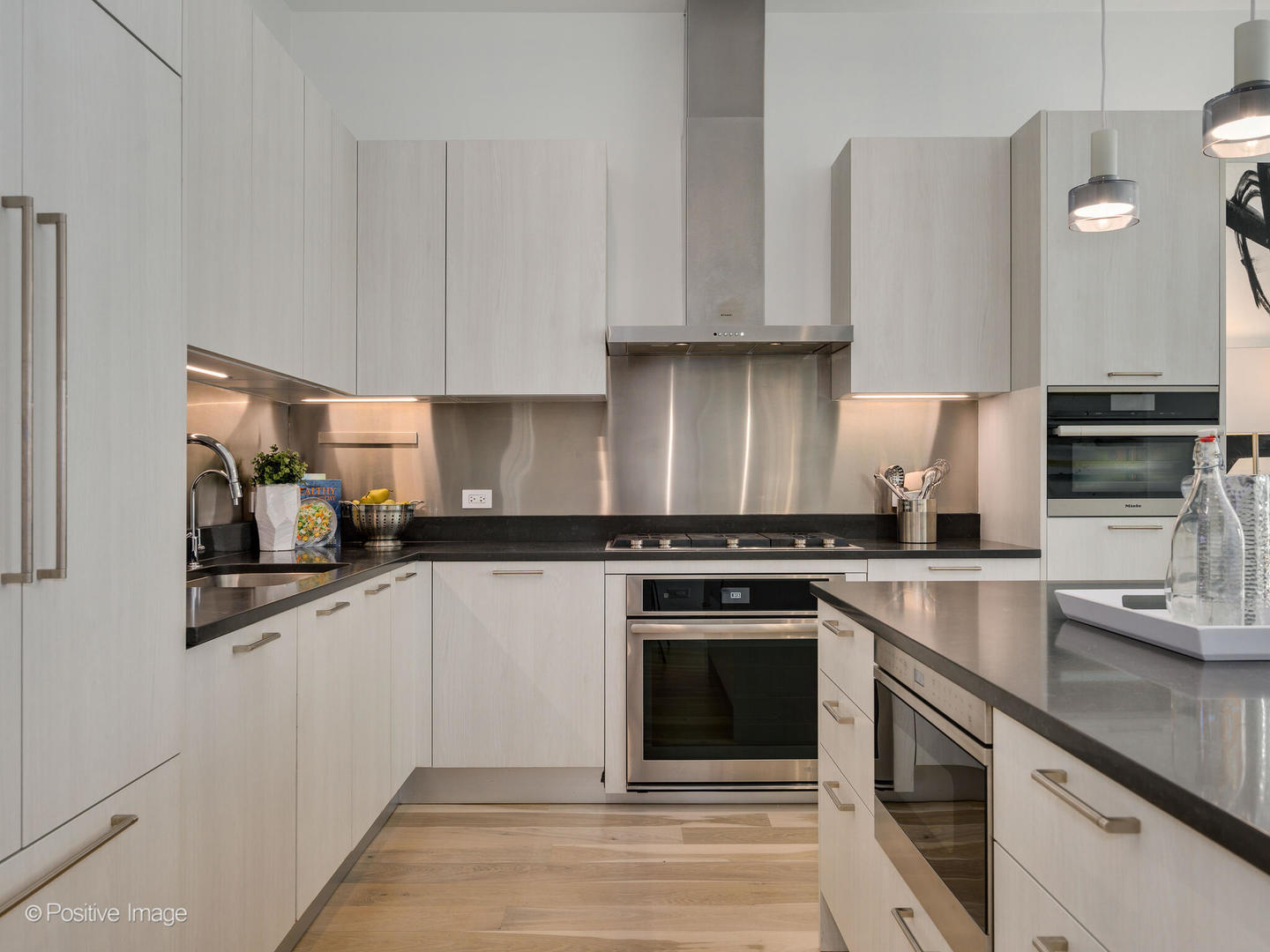 39 North Aberdeen Street, Unit 4S Chicago, IL 60607 - Photo 7 of 25 a kitchen with stainless steel appliances granite countertop a stove a sink and a microwave