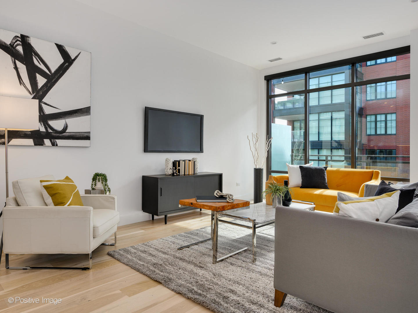 39 North Aberdeen Street, Unit 4S Chicago, IL 60607 - Photo 9 of 25 a living room with furniture a flat screen tv and a floor to ceiling window