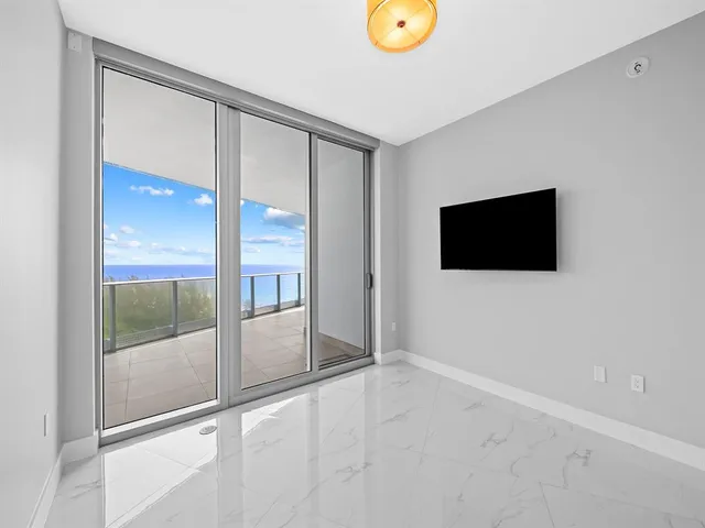 a spacious bathroom with a tub sink and mirror