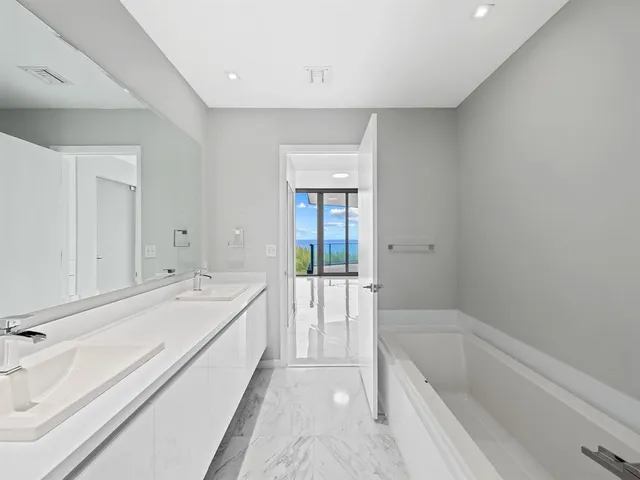 a bathroom with a double vanity sink mirror and shower