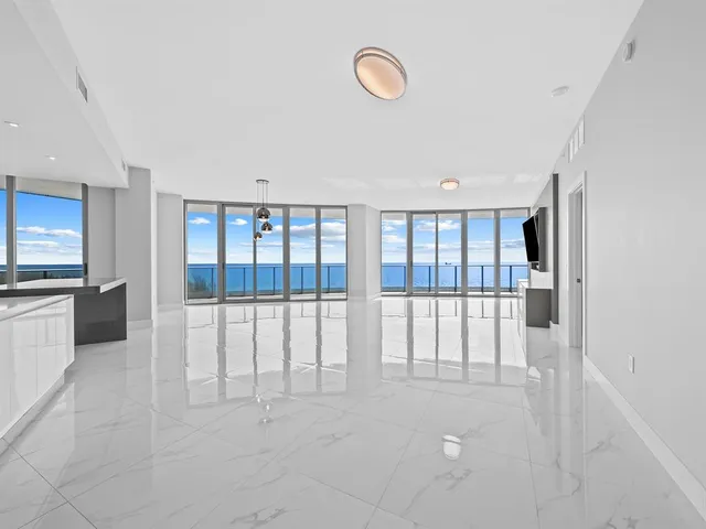 a kitchen with stainless steel appliances granite countertop a sink and a refrigerator