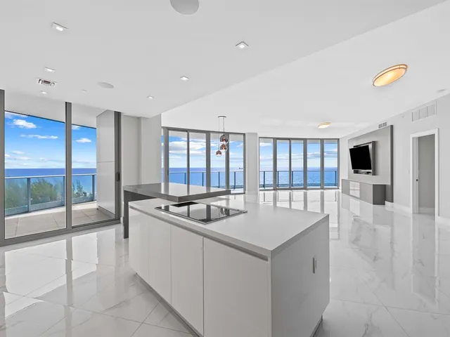 a view of an empty room with furniture and a flat screen tv