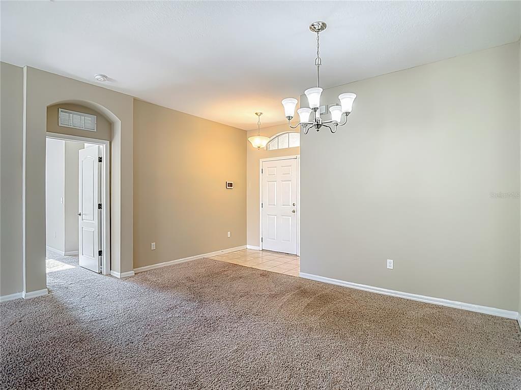 8942 Sandusky Lane New Port Richey, FL 34654 - Photo 12 of 87 a view of a chandelier in a room and a mirror