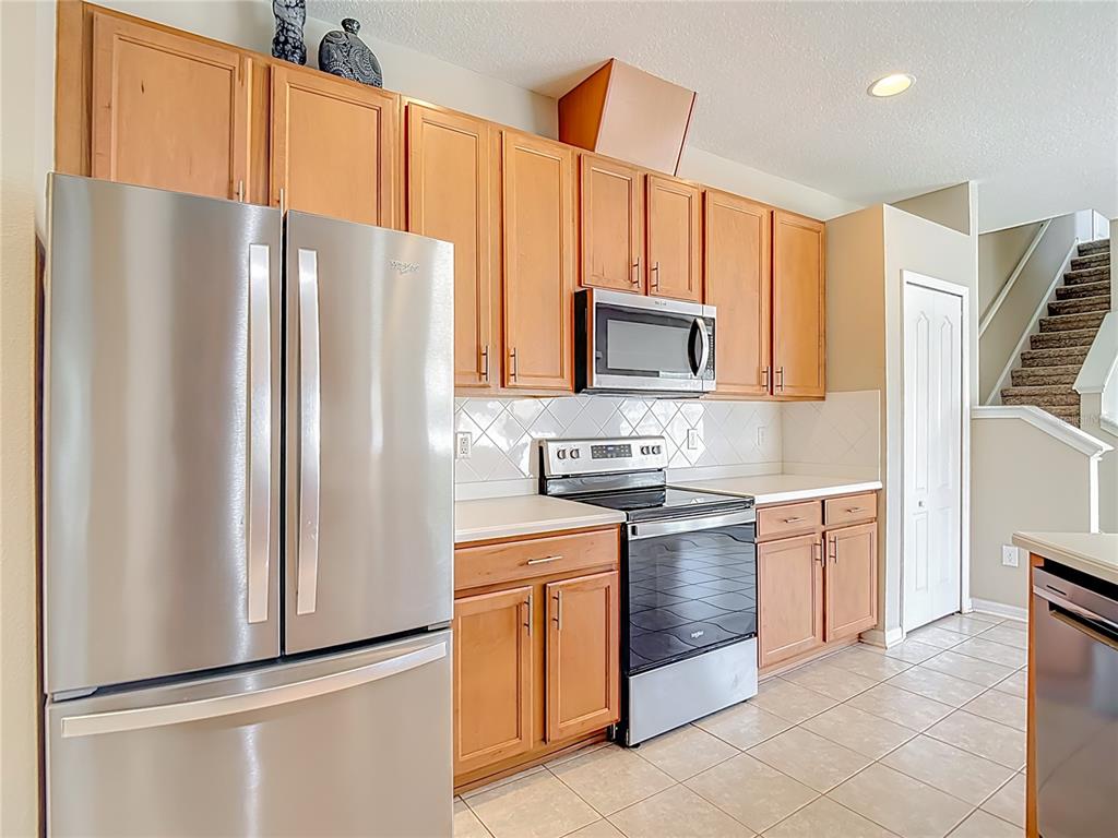 8942 Sandusky Lane New Port Richey, FL 34654 - Photo 16 of 87 a kitchen with stainless steel appliances a refrigerator sink and microwave