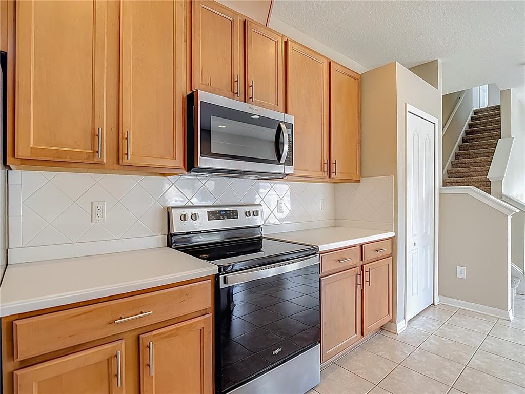 8942 Sandusky Lane New Port Richey, FL 34654 - Photo 17 of 87 a kitchen with a stove microwave and sink
