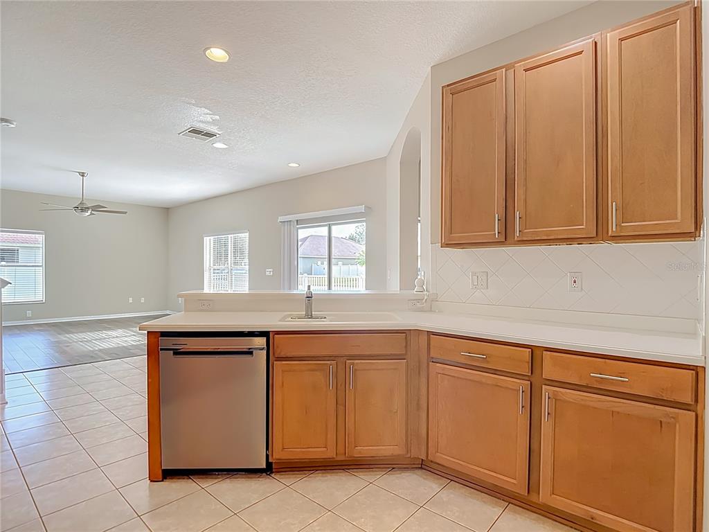 8942 Sandusky Lane New Port Richey, FL 34654 - Photo 18 of 87 a kitchen with white cabinets sink and window
