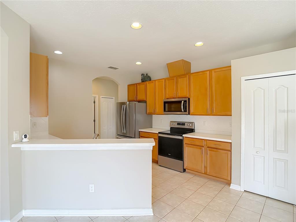 8942 Sandusky Lane New Port Richey, FL 34654 - Photo 23 of 87 a kitchen with stainless steel appliances granite countertop a stove a sink and a refrigerator