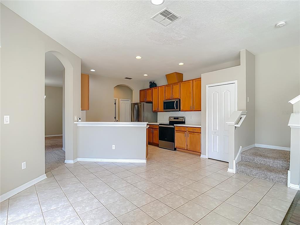 8942 Sandusky Lane New Port Richey, FL 34654 - Photo 24 of 87 a kitchen with stainless steel appliances a refrigerator and a stove
