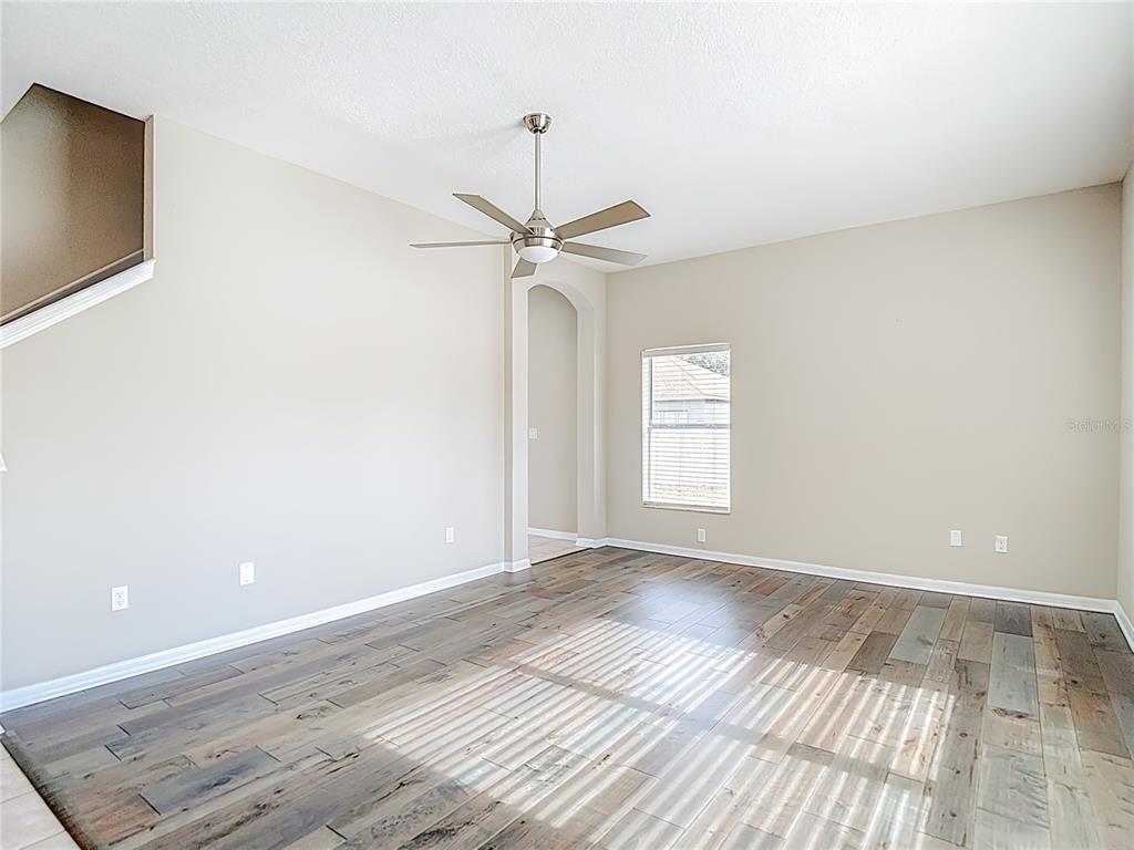 8942 Sandusky Lane New Port Richey, FL 34654 - Photo 27 of 87 a view of empty room with wooden floor and fan