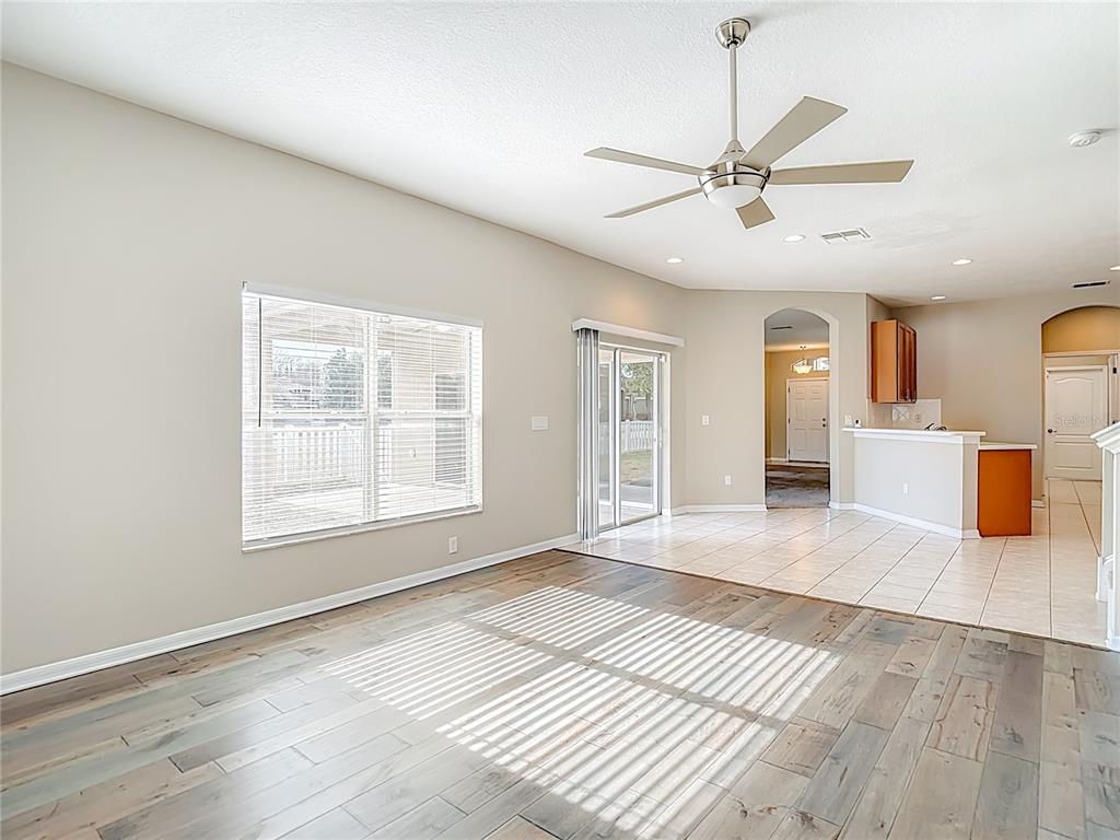 8942 Sandusky Lane New Port Richey, FL 34654 - Photo 29 of 87 a view of an empty room with a window and wooden floor