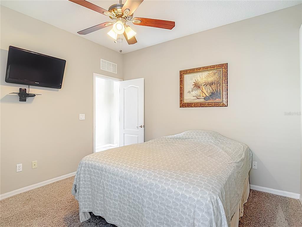 8942 Sandusky Lane New Port Richey, FL 34654 - Photo 33 of 87 a bedroom with a bed and a flat screen tv