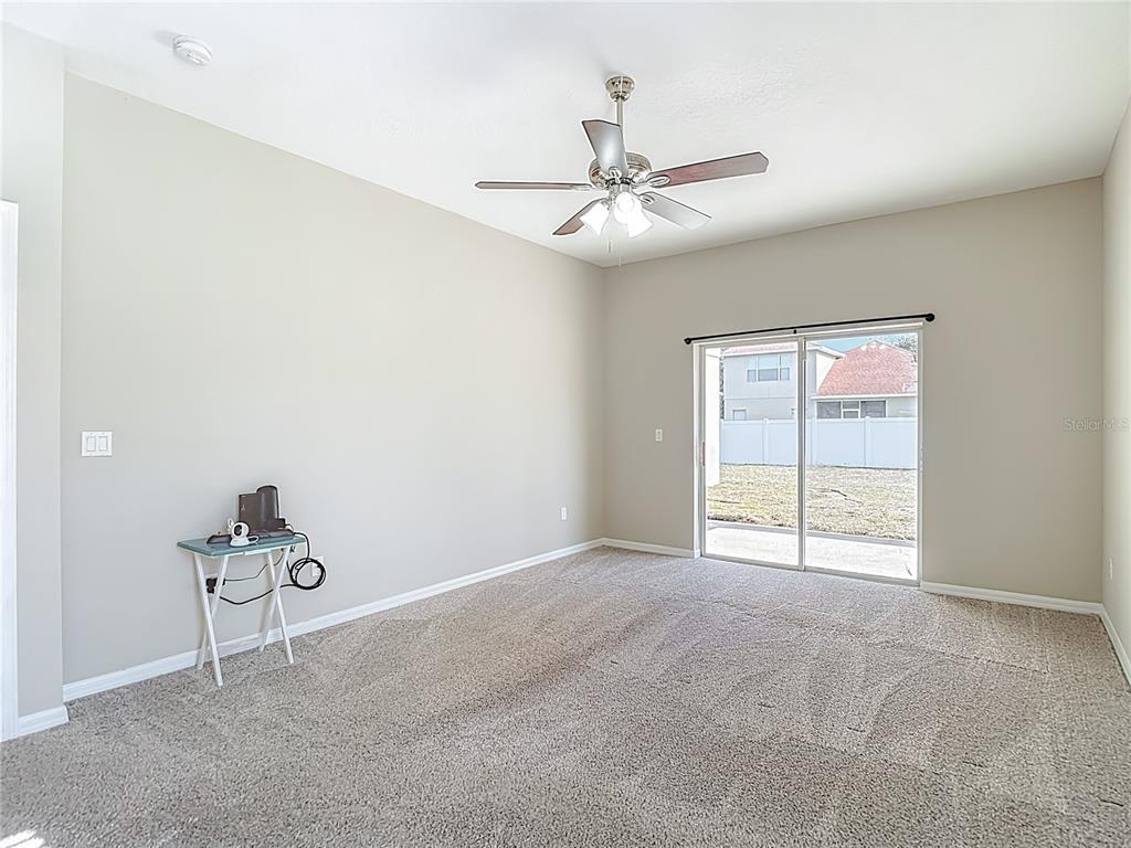 8942 Sandusky Lane New Port Richey, FL 34654 - Photo 40 of 87 an empty room with windows and fan