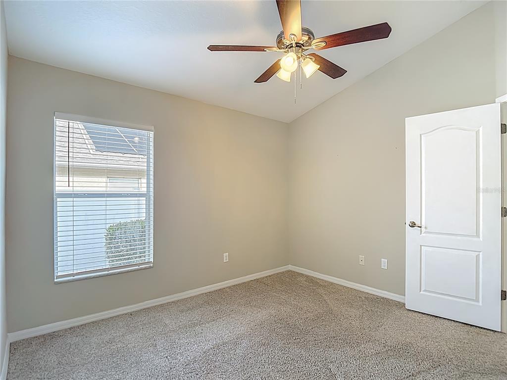 8942 Sandusky Lane New Port Richey, FL 34654 - Photo 58 of 87 an empty room with windows and fan