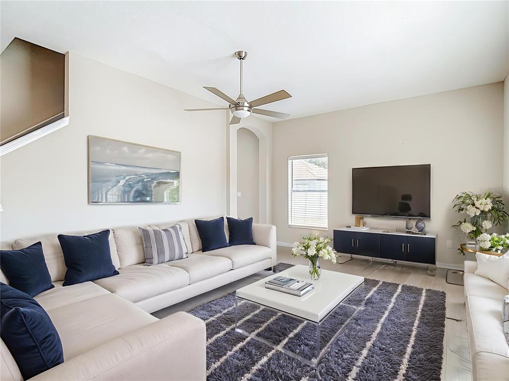 8942 Sandusky Lane New Port Richey, FL 34654 - Photo 6 of 87 a living room with furniture and a flat screen tv