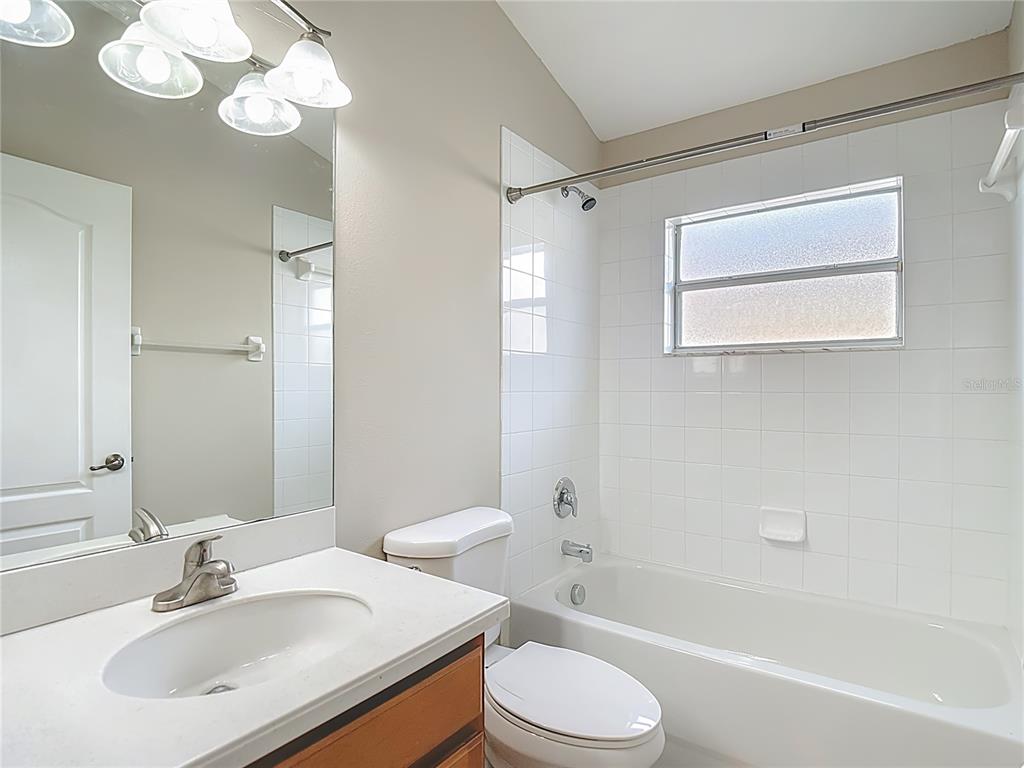 8942 Sandusky Lane New Port Richey, FL 34654 - Photo 63 of 87 a bathroom with a sink a toilet a mirror a bathtub and shower