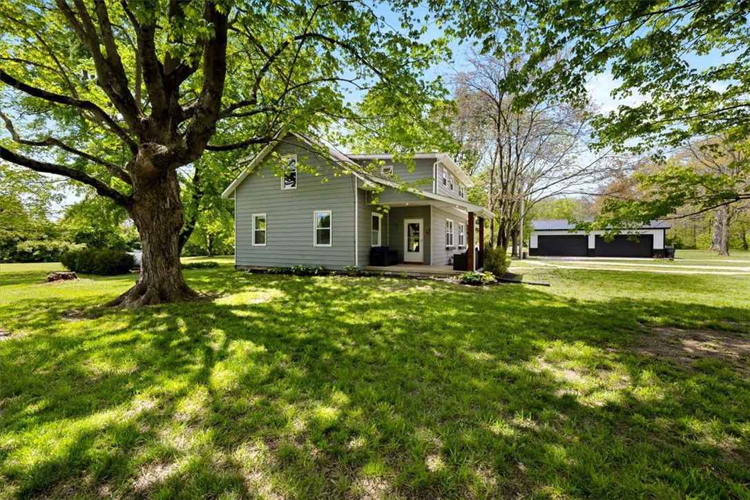 5120 Wheelock Road Troy, OH 45373 - Photo 2 of 67 This residence features a welcoming exterior, complemented by a detached garage and verdant surroundings.