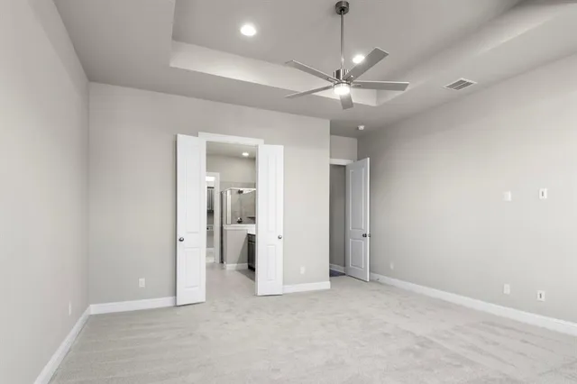 an empty room with fan and entrance