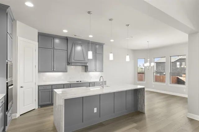 a kitchen with a sink cabinets and window