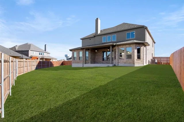 a front view of a house with a yard table and chairs