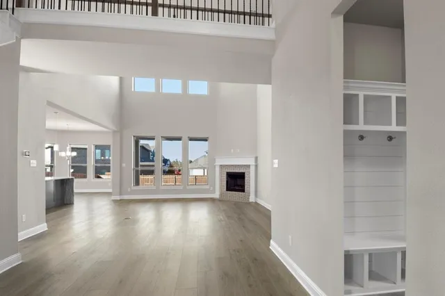 a view of a living room and kitchen with furniture and wooden floor