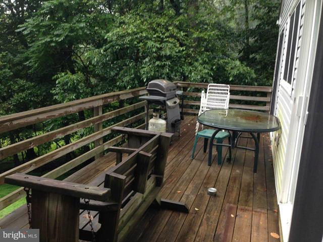 341 Luchase Road Linden, VA 22642 - Photo 14 of 30 a view of a balcony with chairs and wooden floor