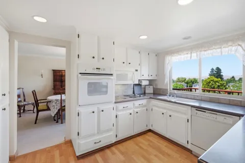 a view of a dining room with furniture and window