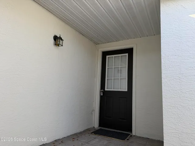a view of an empty room with closet